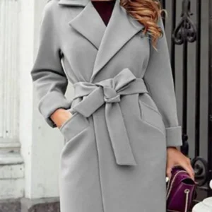 Winter elegance, redefined. This mid-length wool blend coat features a classic lapel, solid color, and cozy knit for effortless style and warmth."